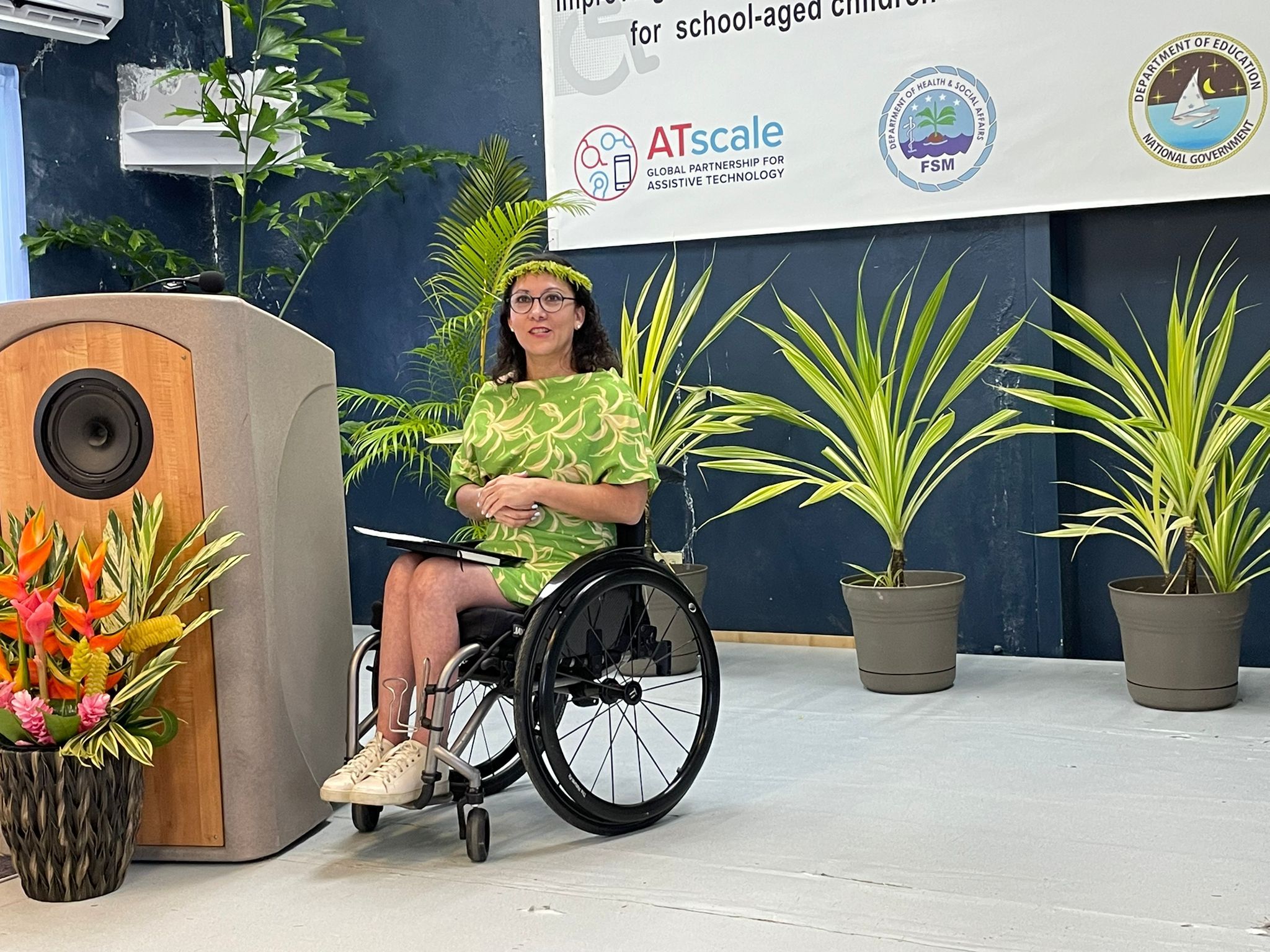 Karen of ATscale delivering her remarks. She is in her wheelchair