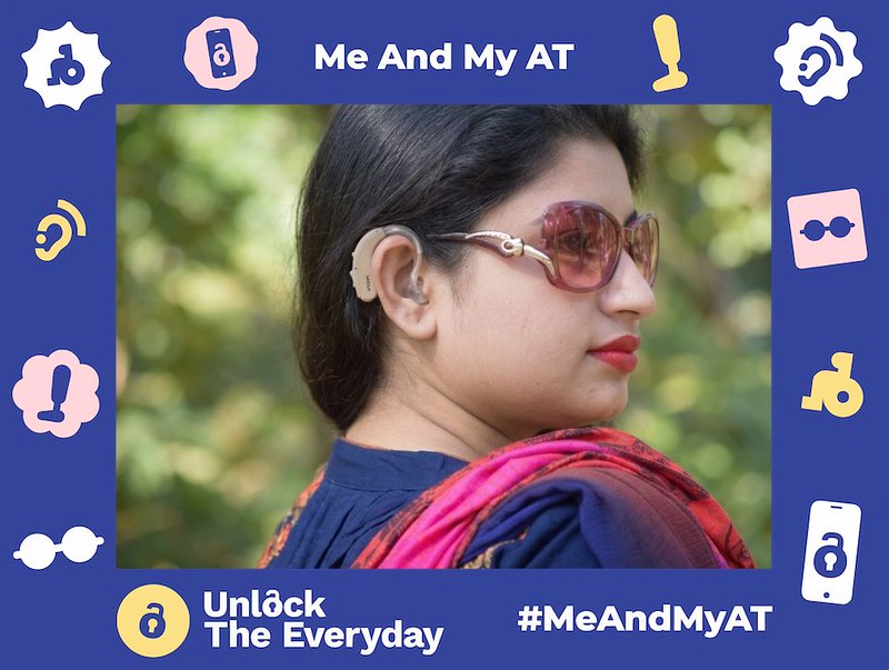 Close-up profile of a woman wearing a behind-the-ear hearing aid, set within a blue campaign graphic framed by accessibility icons, "#MeAndMyAT", and "Unlock The Everyday".