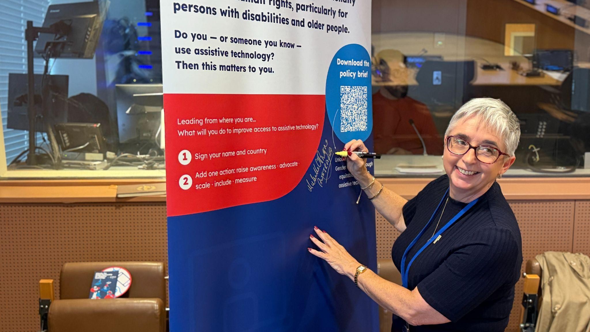 Michelle O’Byrne, Australia’s Ambassador for Gender Equality signing a commitment to continue advocating for affordable and accessible AT