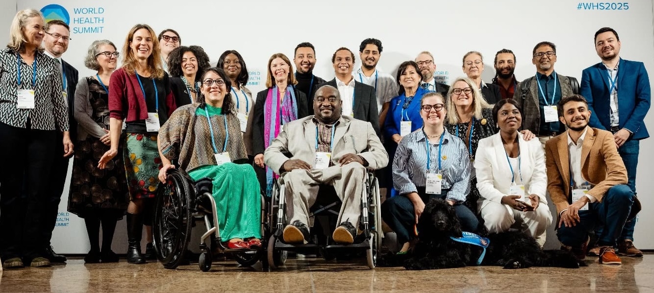 a group photo of attendees of the event who are standing, and some sitting down