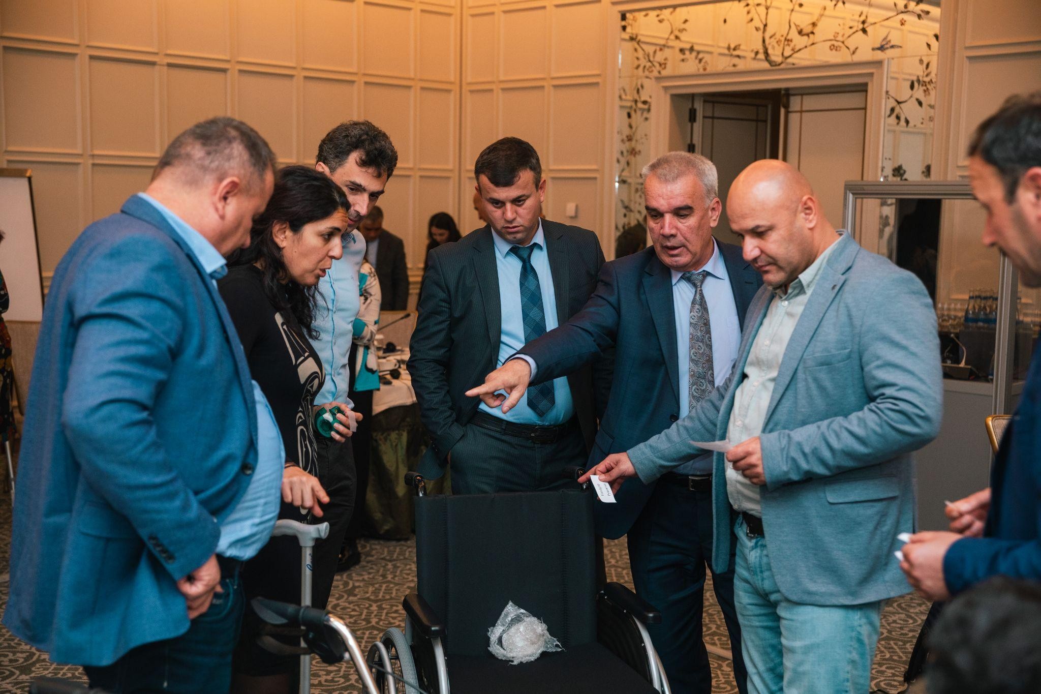 Trainees of a workshop on assistive product specifications and quality standards in Baku (Azerbaijan) look at different parts of assistive products and evaluate them for quality and durability. November 28-29, 2024.Photo credit:  WHO Azerbaijan