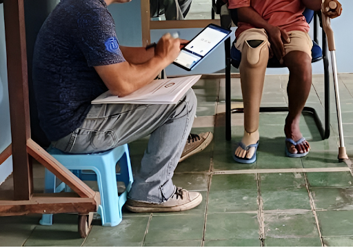 Data collection with lower-limb prosthesis users during the pilot phase of the LEAD and COMPASS project; a custom-built app is used to collect the results of the selected outcome measures. Photo credit: ISPO