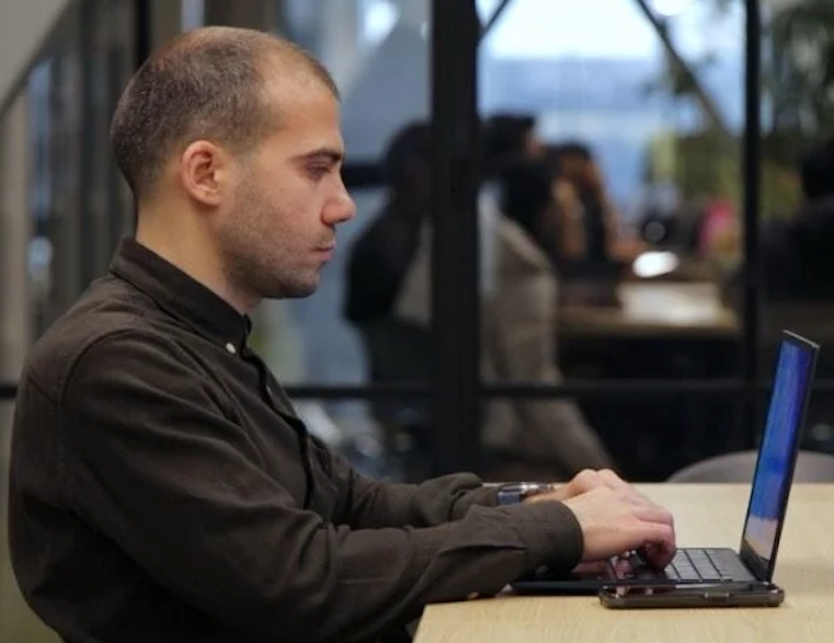 Davit Bibileishvili, a lecturer and a disability rights activist in Georgia, working on his accessible computer.