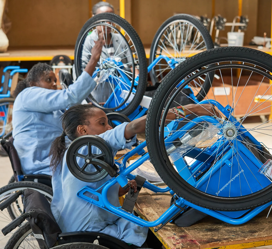 Workers in a workshop in Kenya, who are wheelchair users themselves, are assembling wheelchairs for local distribution. Photo credit: Walkabout Foundation.