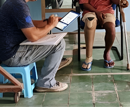 Data collection with lower-limb prosthesis users during the pilot phase of the LEAD and COMPASS project; a custom-built app is used to collect the results of the selected outcome measures. Photo credit: ISPO