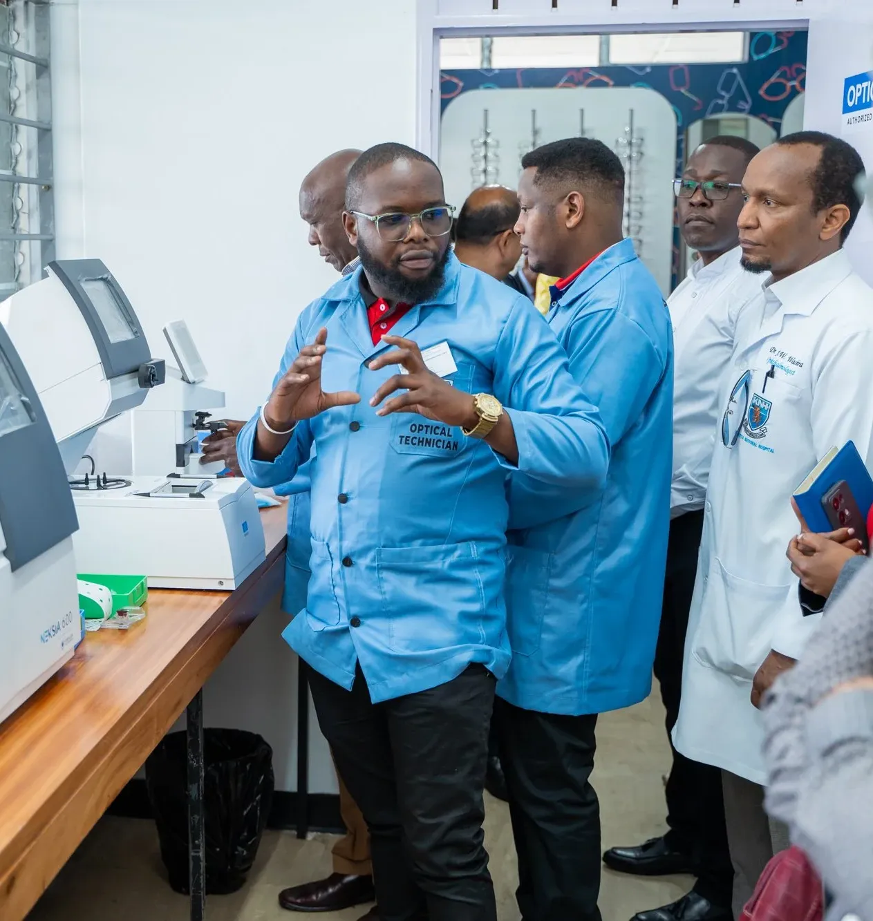 Joshua Tiisa, optical technician at Kenyatta Hospital providing an insightful demonstration  on the functionality of a newly-acquired machine that cuts lenses