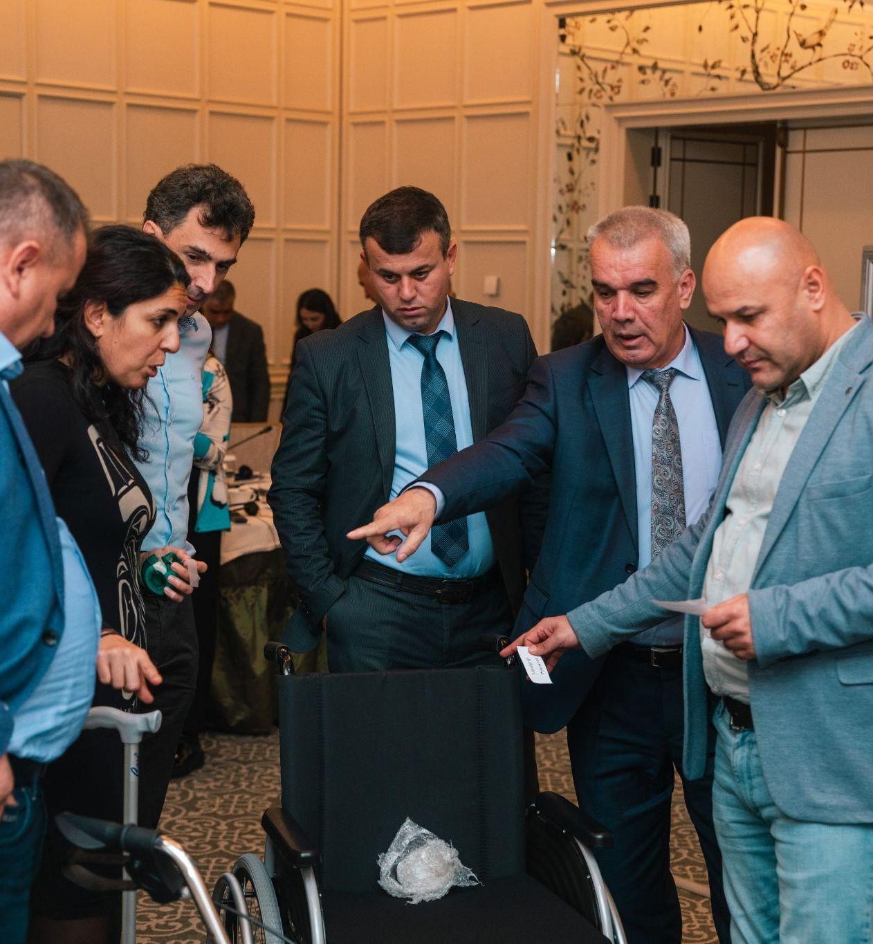 Trainees of a workshop on assistive product specifications and quality standards in Baku (Azerbaijan) look at different parts of assistive products and evaluate them for quality and durability. November 28-29, 2024.Photo credit:  WHO Azerbaijan