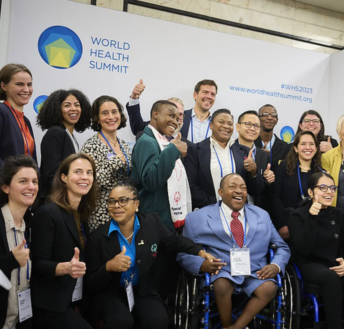 Members of the disability-inclusive health consortium posing after their session with Ilona Kickbusch, Founding Director of WHS