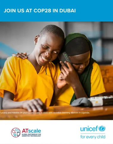 wo schoolgirls in Uganda use an assistive learning device together in class, smiling and listening, with ATscale and UNICEF logos below.