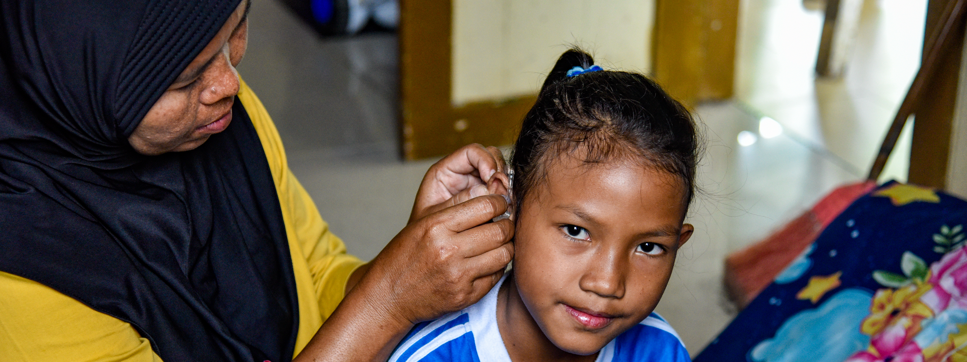 Misyati helps her daughter Renata Salsa Azhari (Rere), 11, prepare for school in Purbalingga, Indonesia.