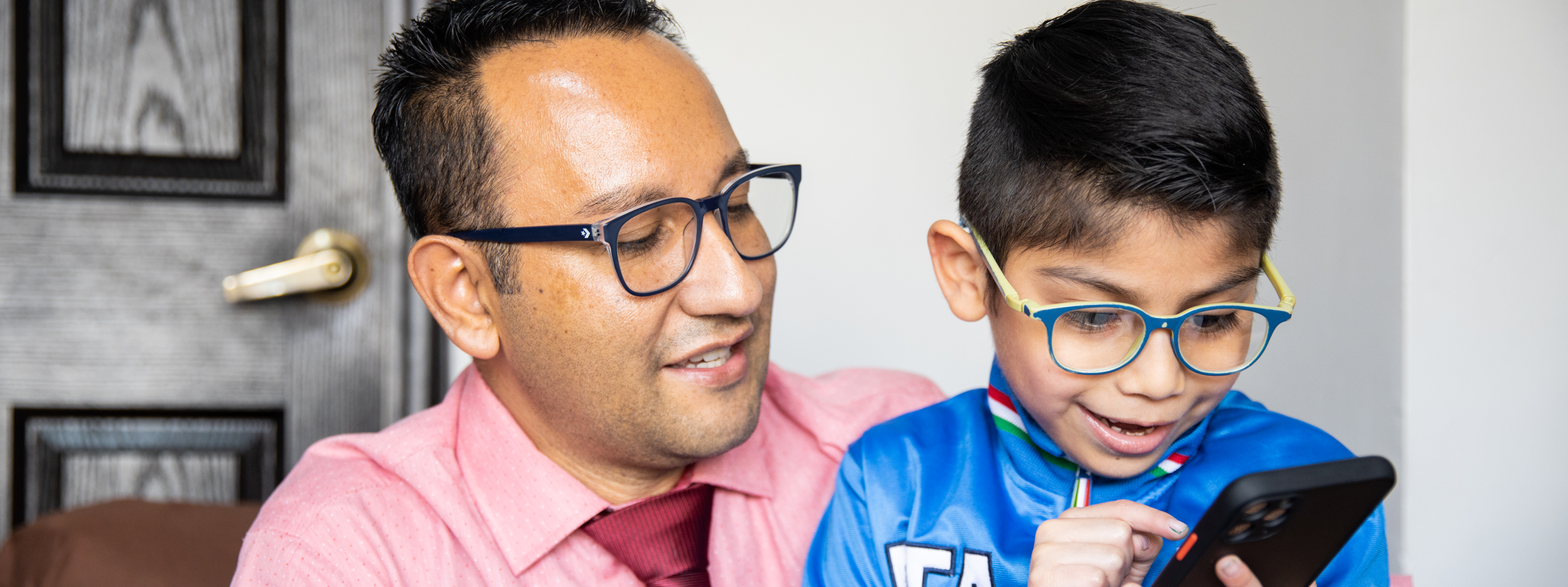 Estuardo Antonio Aquino Sandoval (42 years) shows a picture to his son, Debyan Angel Estuardo Aquino Santiago (7 years old), in their home in Quetzaltenango, Guatemala. Debyan has autism