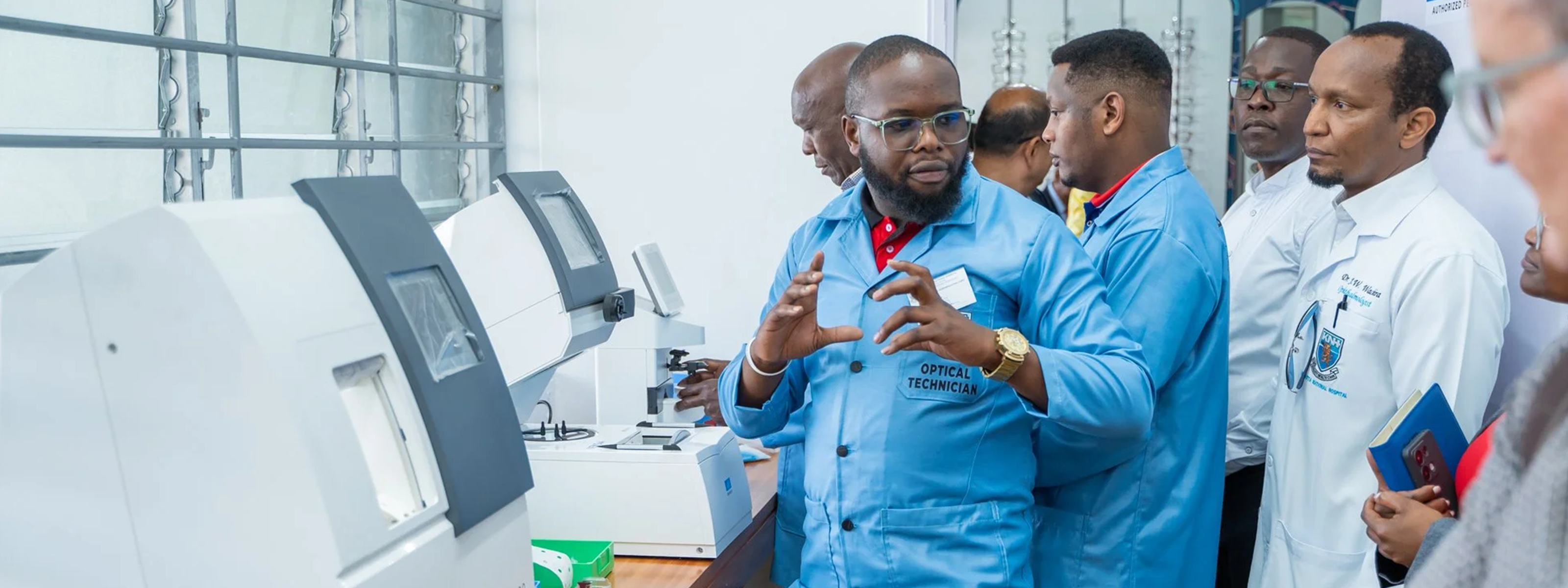 Joshua Tiisa, optical technician at Kenyatta Hospital providing an insightful demonstration  on the functionality of a newly-acquired machine that cuts lenses. Patients do not have to go elsewhere with their prescription for glasses but can receive them in the same place